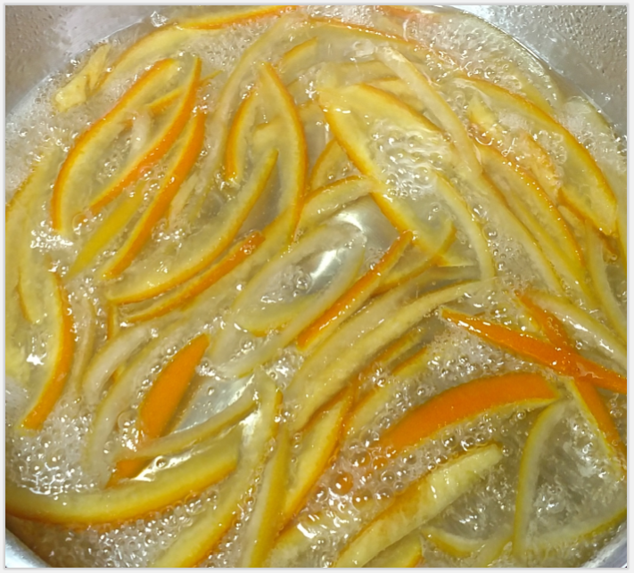 Orange peels sizzling in simple syrup. 
