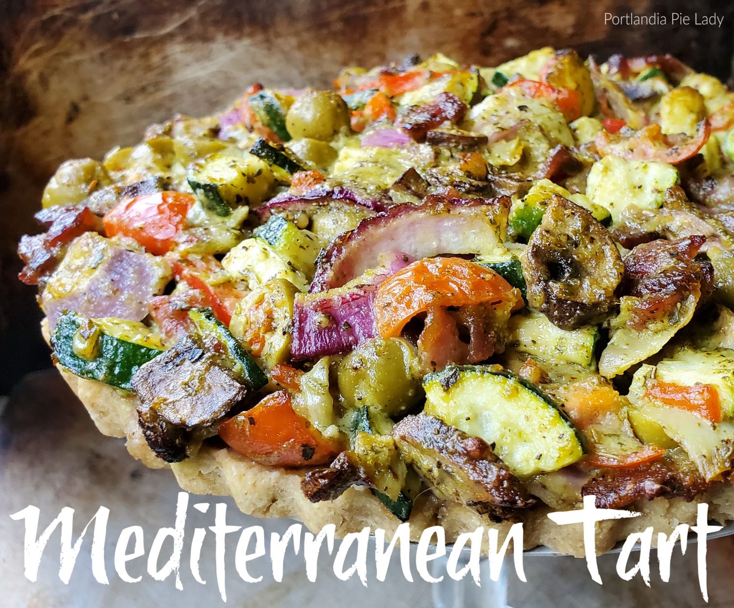 Mediterranean vegetables tossed with a flavorful creamy pesto sauce and seasonings which bakes up tender crisp,with a savory walnut-almond crust. 