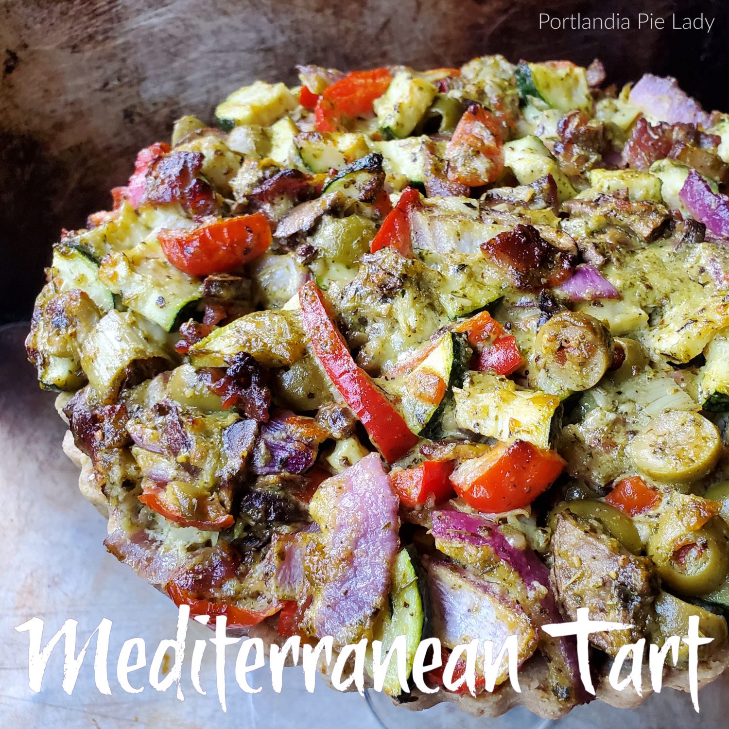 Mediterranean vegetables tossed with a flavorful creamy pesto sauce and seasonings which bakes up tender crisp,with a savory walnut-almond crust. 