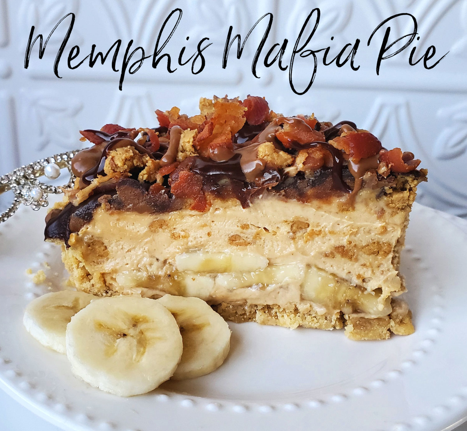 Memphis Mafia Pie: Vanilla wafer crust, peanut butter filling, bananas, homemade "Reeses" crumbles, drizzled with peanut butter fudge, chocolate ganache & bacon! 