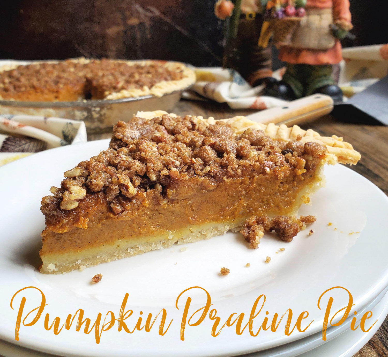 Pumpkin Praline Pie; a spiced pumpkin pie baked with a brown sugar-pecan praline topping & a dollop of whipped cream. Pumpkin pie game changer.