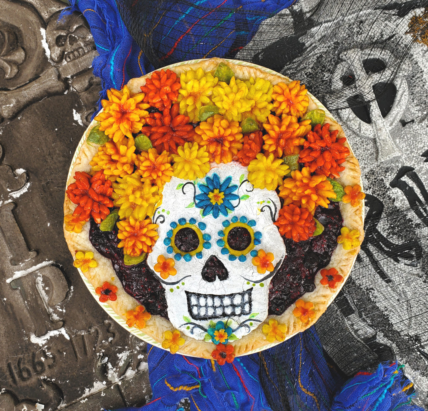 Dia de Muertos with pie crust marigolds for the perfect headdress for your Catrina Calavera on a triple berry pie, honoring the dead!