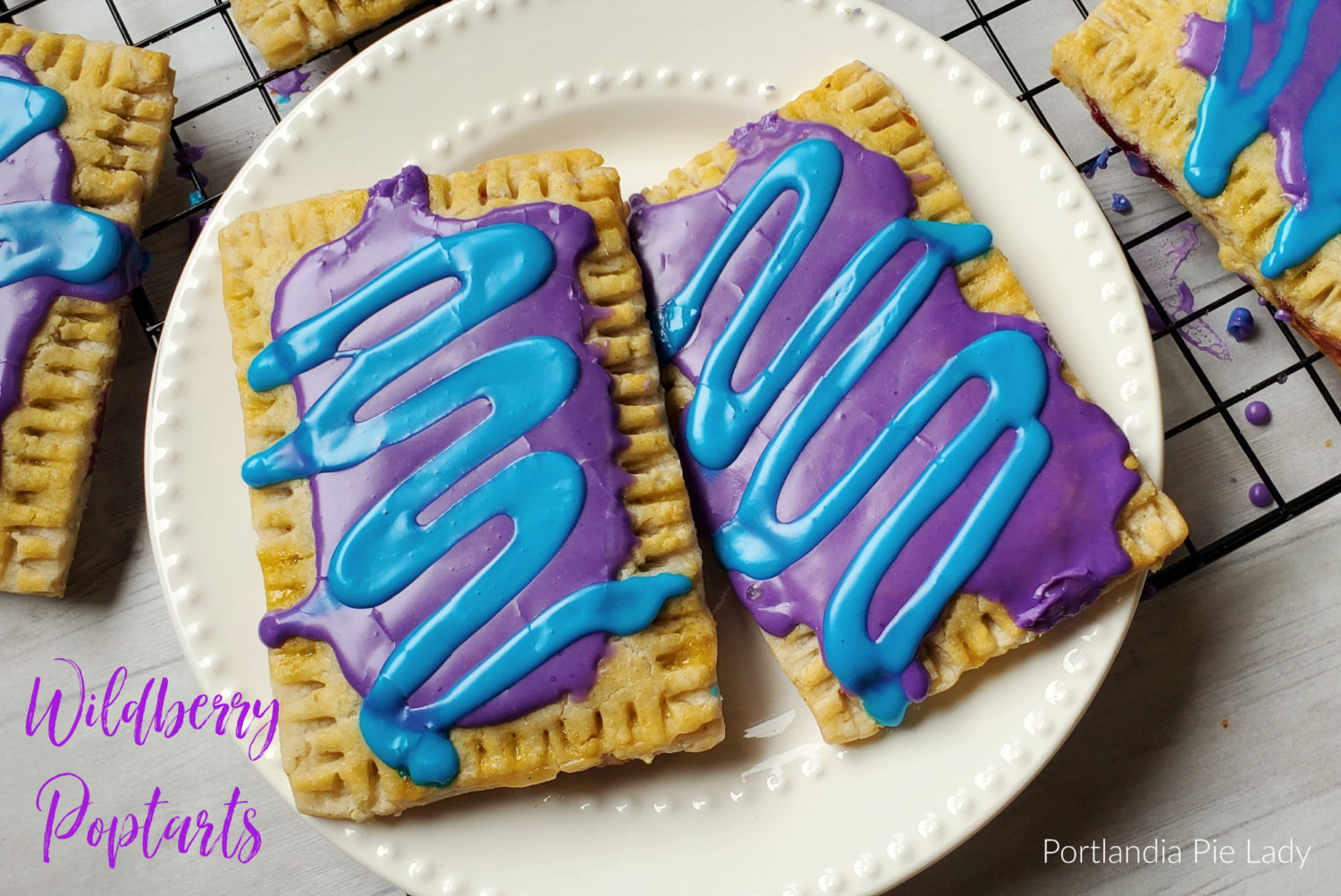 Wildberry Poptarts from your very own kitchen; buttery tender crust, homemade wildberry filling, and trademark violet & sky blue icing. 