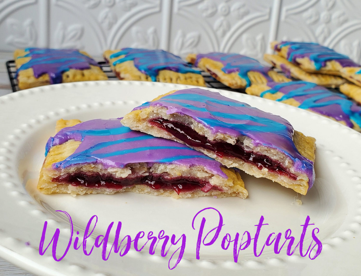 Wildberry Poptarts from your very own kitchen; buttery tender crust, homemade wildberry filling, and trademark violet & sky blue icing. 