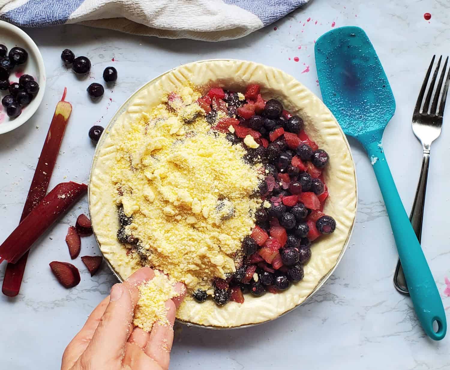 Blueberry Rhubarb Pie & sweet cornmeal crumble topping: sweet blueberries & tart rhubarb with lemon zest and vanilla.