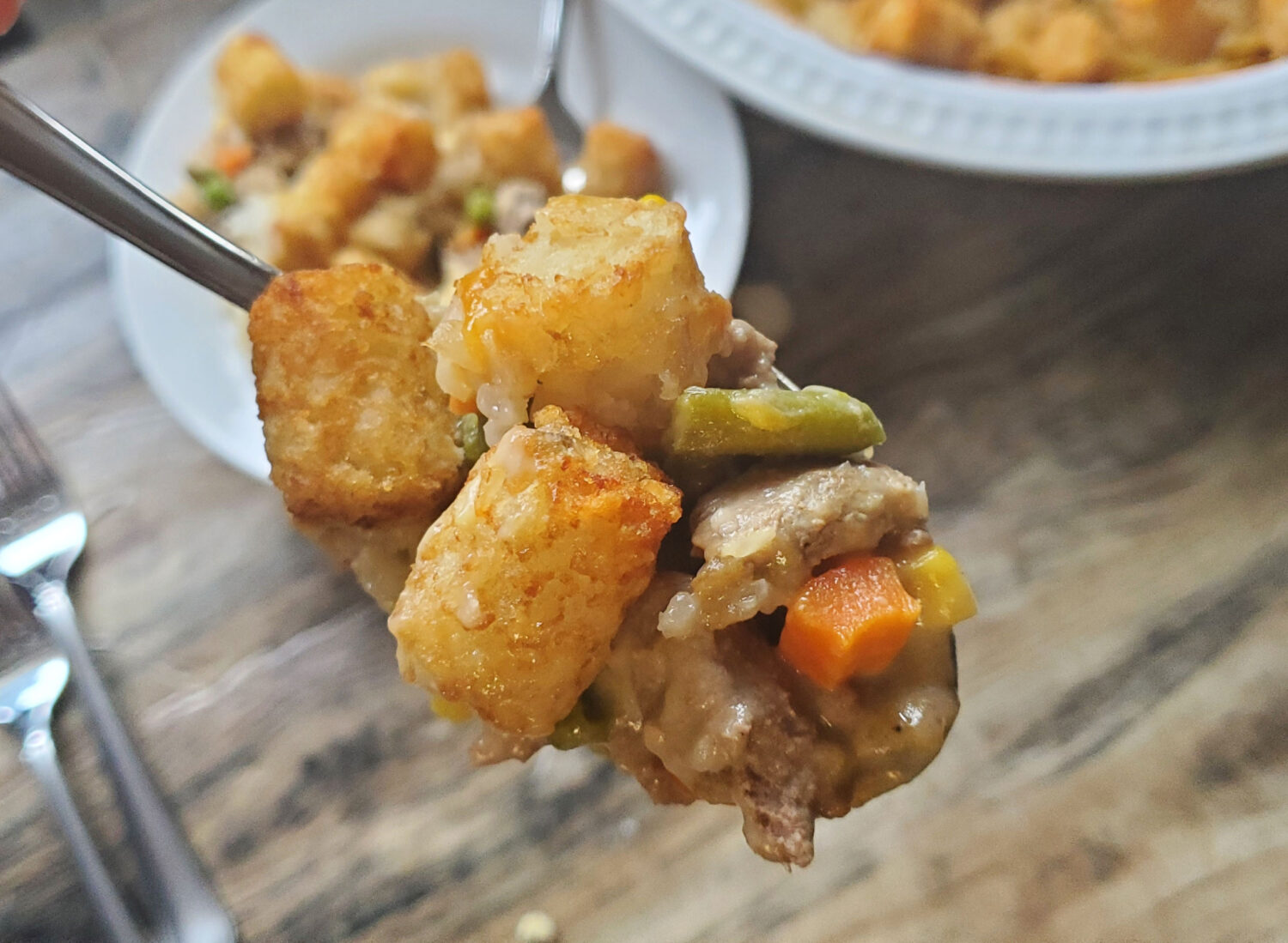 Cheesy Tater Tot Dinner Pie: Ground beef or turkey and veggies baked in a cheese bechamel sauce and topped with crispy Tater Tots!