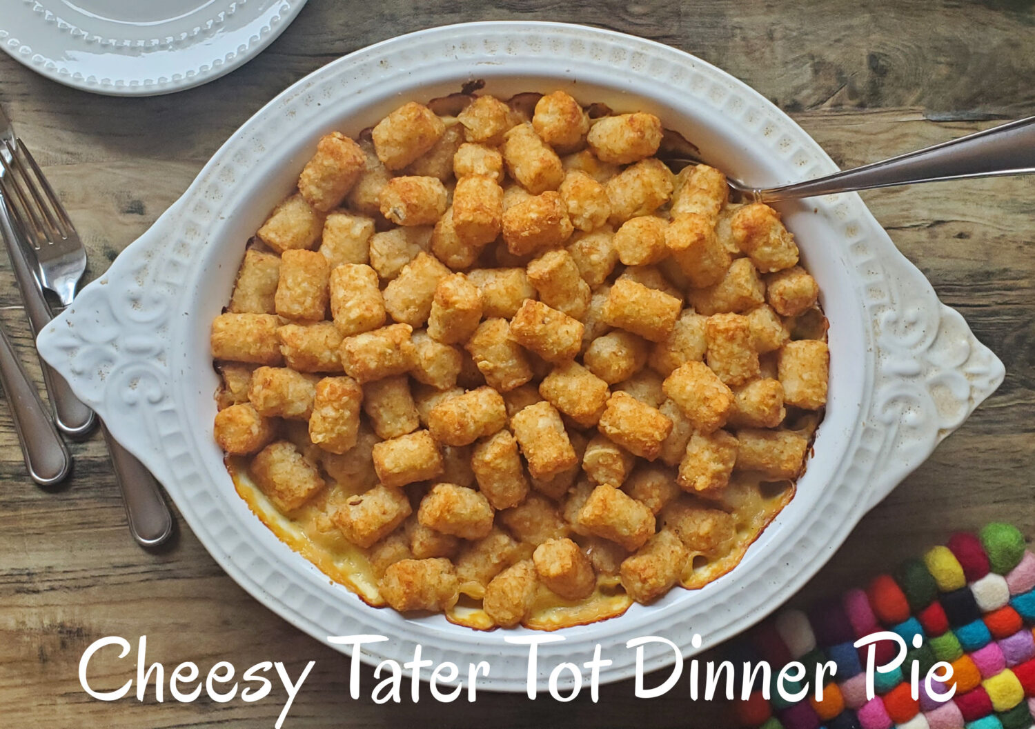 Cheesy Tater Tot Dinner Pie: Ground beef or turkey and veggies baked in a cheese bechamel sauce and topped with crispy Tater Tots!
