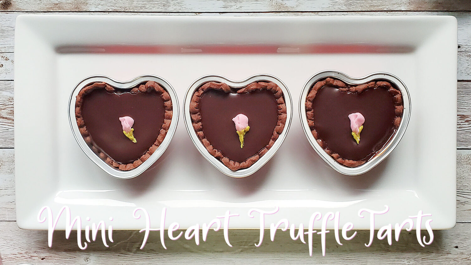Decadent chocolate truffle filling in a dark chocolate crust, & a ganache glaze, baked into mini hearts. Perfect for Valentines Day!