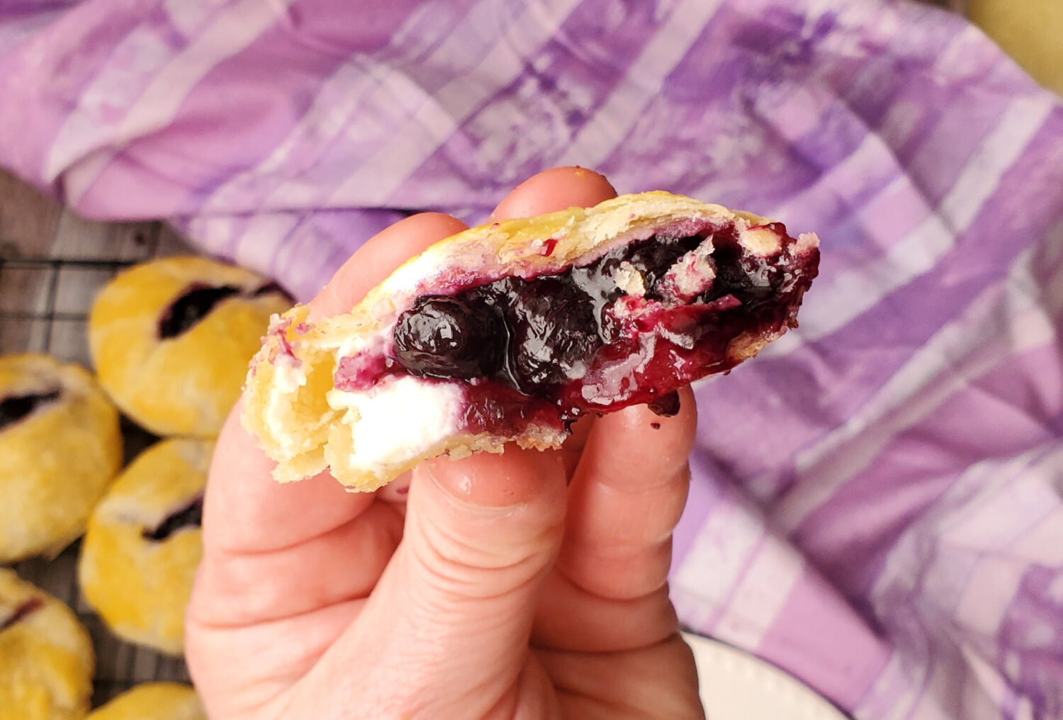 Blueberry Cream Pie Poppers are the perfect two-bite luscious berry mini pies that are easy to make, same buttery flaky crust, snack size.  Half the amount of crust of hand pies, but all the filling crammed into a mini!