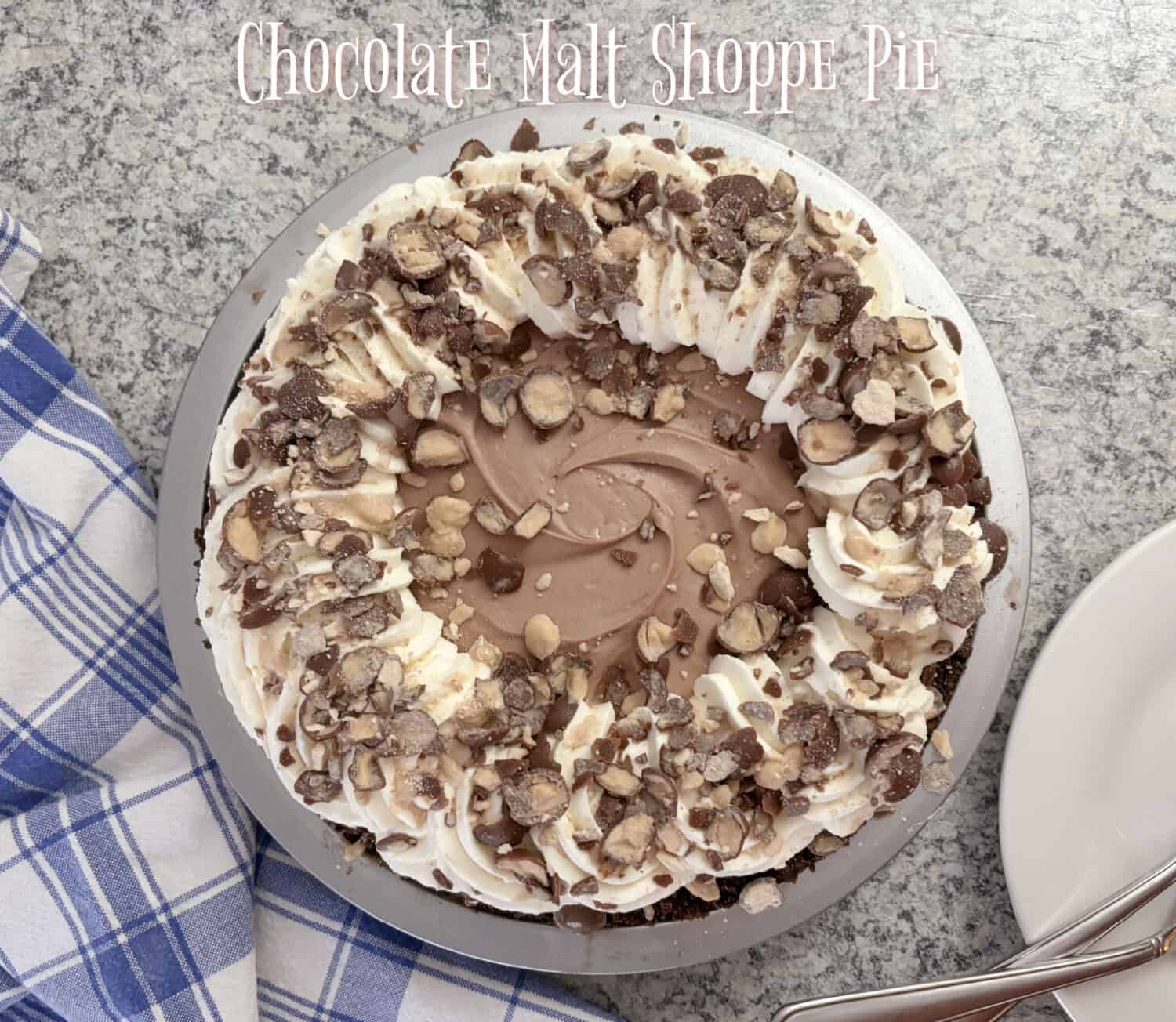 Chocolate Malt Pie, creamy chocolate malt marshmallow-cream cheese filling., with whipped cream; garnished with crushed malted milk balls.