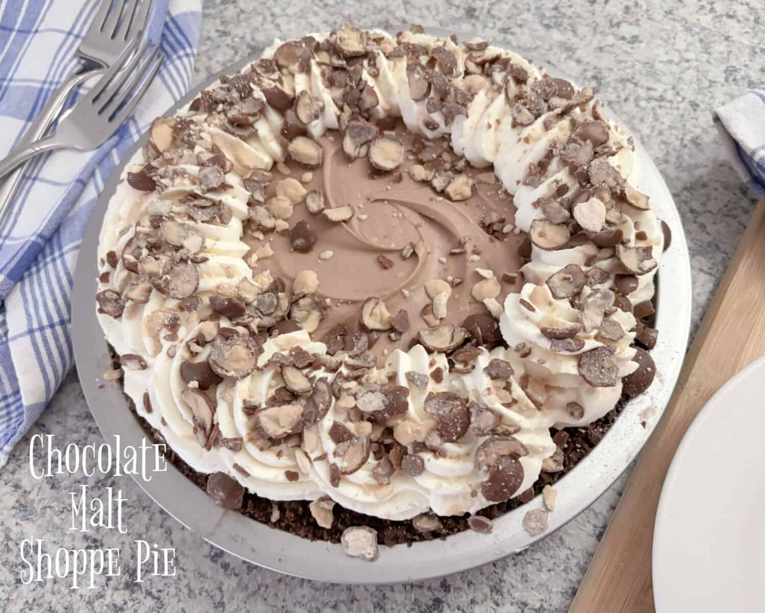 Chocolate Malt Pie, creamy chocolate malt marshmallow-cream cheese filling., with whipped cream; garnished with crushed malted milk balls.