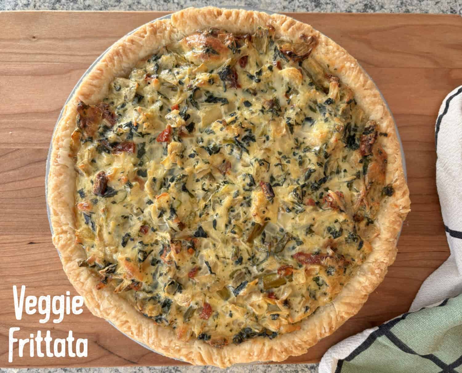 Veggie Frittata: Loads of sweet onions, asparagus, & spinach baked with parmesan and swiss cheeses in a savory egg-sour cream filling.