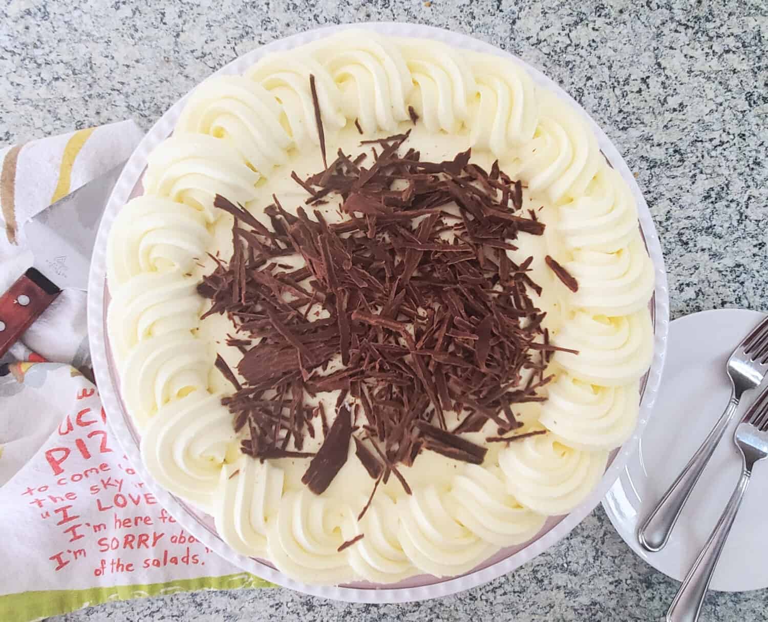 Hidden layers of luscious cream cheese filling, decadent homemade chocolate pudding, hiding under whipped cream in a pecan shortbread crust.