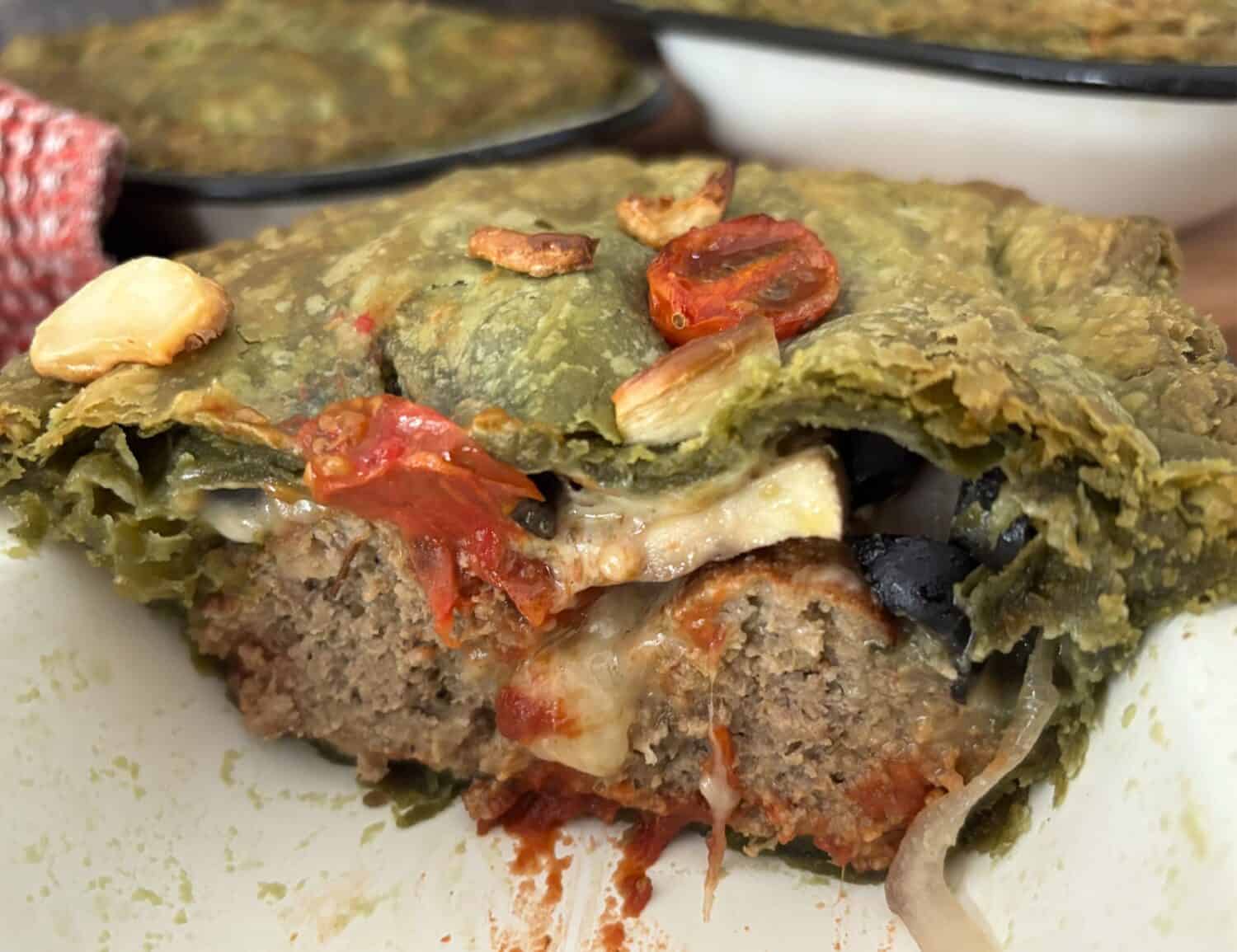 Italian Meatballs paired marinara sauce, Italian cheeses and veggies, all baked in a spinach pastry crust. It's where pizza meets spaghetti and meatballs in an Italian pot pie feast. 